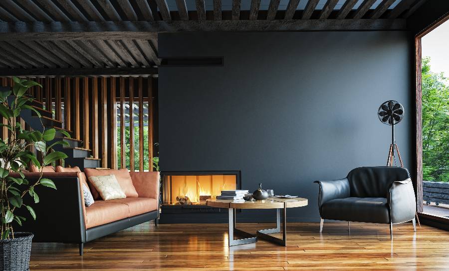 Modern living room with orange sofa, black chair, fireplace, and wooden floors